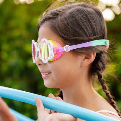 Colorful Bling 2O Sunlit Sherry swim goggles worn by a girl beside a pool with a swimming noodle.