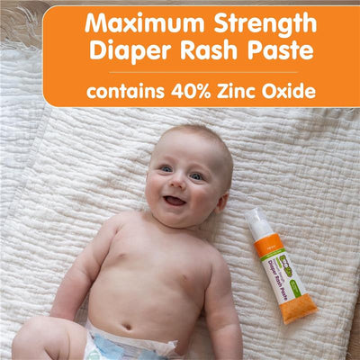Smiling baby lying on a blanket next to Boogie Wipes Maximum Strength Diaper Rash Paste packaging with 40% Zinc Oxide.