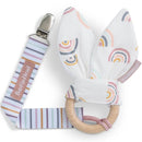 Booginhead 2Pk Bunbun Teether & Pacigrip featuring pastel rainbow-patterned fabric and a natural wood teething ring.