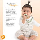 Baby chewing on a sage green pacifier attached to a BooginHead silicone chain, wearing a flower-patterned outfit.