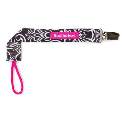Sippie Grip by BooginHead in black flourish design, featuring a clip and pink loop for securing sippy cups.