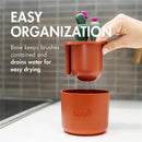 Boon Cacti Bottle Cleaning Brush Set with a brown base for drying, featuring cactus-shaped brushes and water drainage.