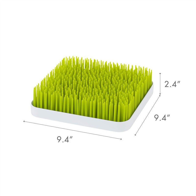 Boon Grass Countertop Drying Rack in green, measuring 9.4 inches square and 2.4 inches tall, designed for drying baby bottles and pacifiers.