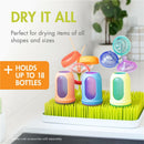 Countertop drying rack in green and white with colorful bottle holders, designed to dry up to 18 bottles of various shapes.
