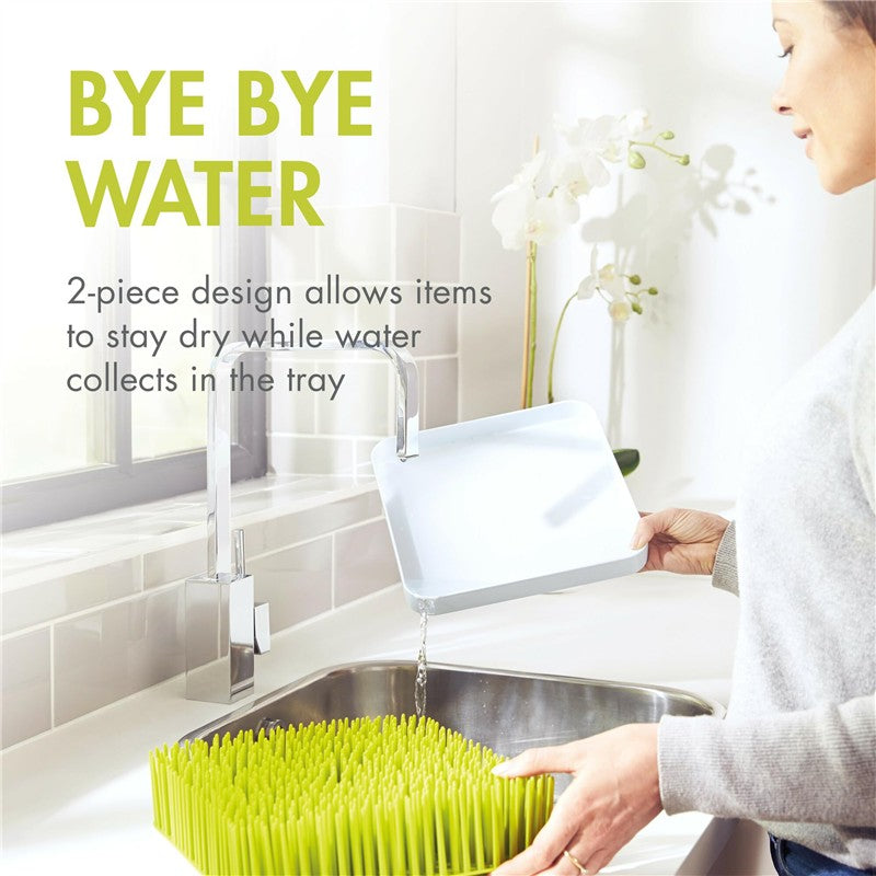 Boon LAWN countertop drying rack in green and white, designed to keep items dry while water collects in the tray.