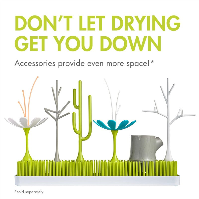 Boon LAWN Countertop Drying Rack in green and white featuring flower and cactus designs, holds drying items with a playful style.