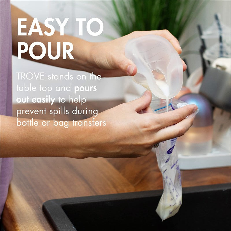Boon TROVE Silicone Breast Milk Collection Cup being tilted to pour milk into a bag, demonstrating its spill-proof feature.