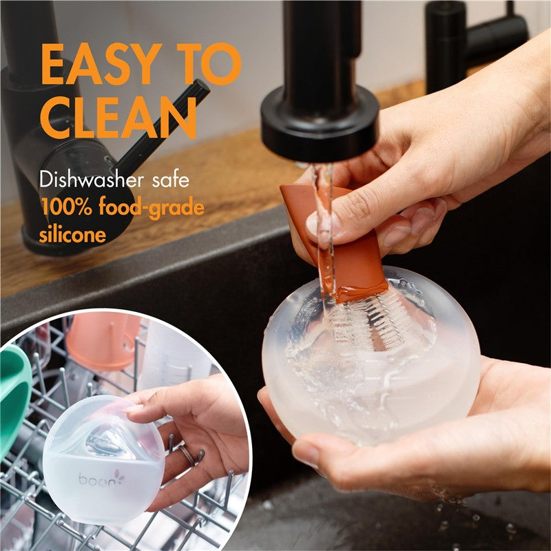 Boon TROVE Silicone Breast Milk Collection Cup being cleaned under running water, highlighting its easy-to-clean feature.