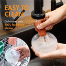 Boon TROVE Silicone Breast Milk Collection Cup being cleaned under running water, highlighting its easy-to-clean feature.