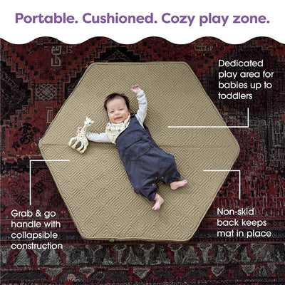 Boppy Foam Play Mat in Natural-Maze Tan, featuring a baby lying on it with a toy, highlighting its non-skid backing and portable design.