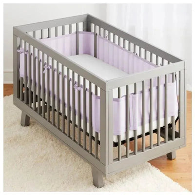 Classic Breathable Baby mesh crib liner in lavender, featuring a gray crib with slatted sides and a soft white mattress.