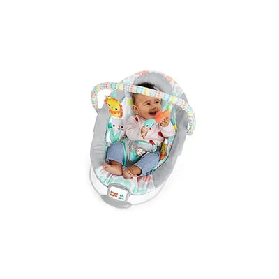 Infant sitting happily in the Bright Starts Whimsical Wild Cradling Bouncer, holding a toy with colorful animal designs.