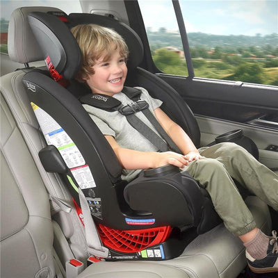 Britax One4Life All in One Convertible Car Seat in Parchment with a smiling child secured in the seat, sitting in a vehicle.