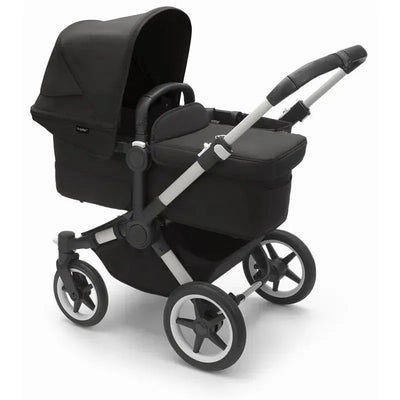 Bugaboo Donkey 5 Mono, a black aluminum stroller featuring a large sun canopy, spacious seat, and multi-terrain wheels.