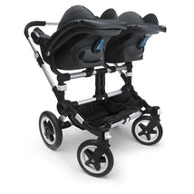 Black twin baby stroller with dual seats and large wheels for smooth rides
