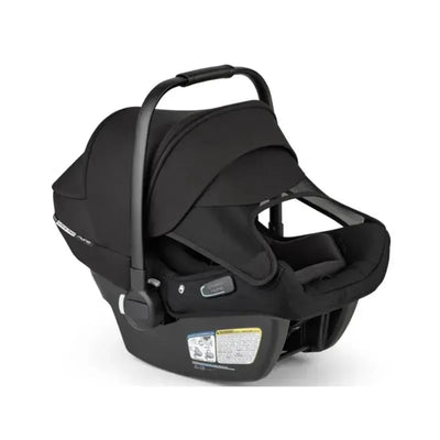 Car seat from Bugaboo - Turtle Air Shield by Nuna, featuring a sleek black design, adjustable handle, and safety labels.