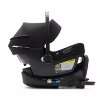 Nuna PIPA Lite LX infant car seat with canopy, black base, and safety labels for newborns and babies