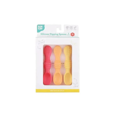 Bumkins silicone dipping spoons in red and two shades of yellow, packaged in a box with care instructions.