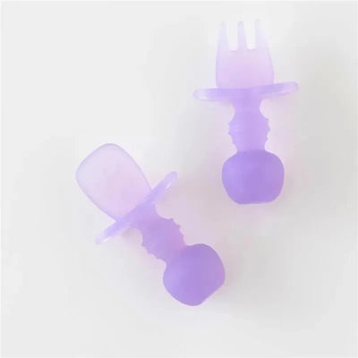Silicone baby utensils set in purple jelly color, including a spoon and a fork with soft, ergonomic grips.