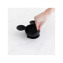 Black silicone bowl featuring Mickey Mouse ears, being held by a hand, suitable for first feeding.