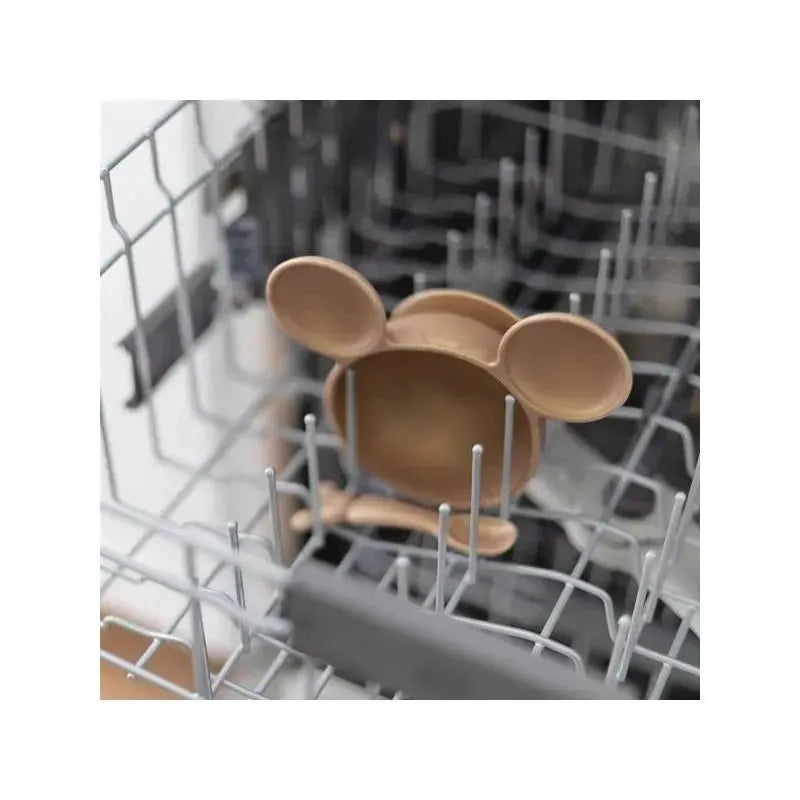 Disney silicone feeding set in dishwasher, featuring a bowl with Mickey Mouse ears and a matching spoon.