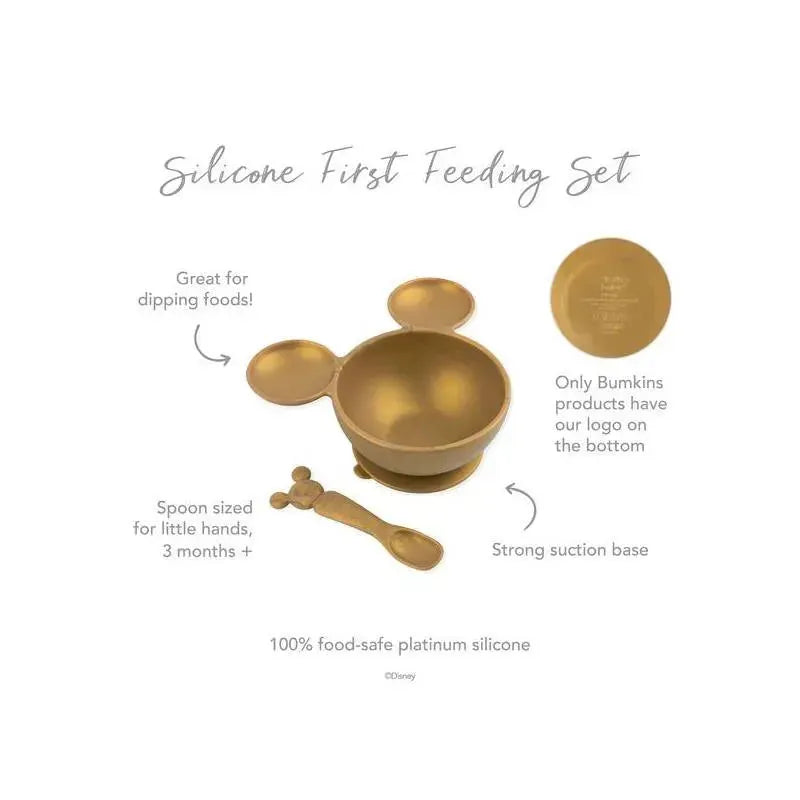 Gold silicone first feeding set featuring a bowl with a Mickey Mouse design and a matching spoon.