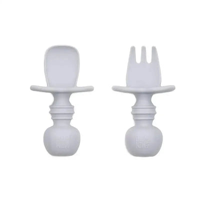 Gray silicone Chewtensils by Bumkins, including a fork and a spoon, designed for toddlers to encourage self-feeding.