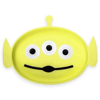Yellow silicone dish shaped like the Toy Story alien character, featuring three eyes and a smiling mouth.