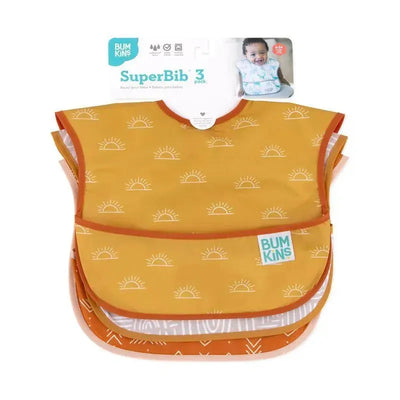 Three-pack of Bumkins SuperBib, featuring desert boho designs with sun patterns and a wipeable, waterproof material.