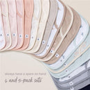 Burts Bees 5-pack Golden Bee lap shoulder bibs in soft colors with floral and striped patterns, featuring brand labels.