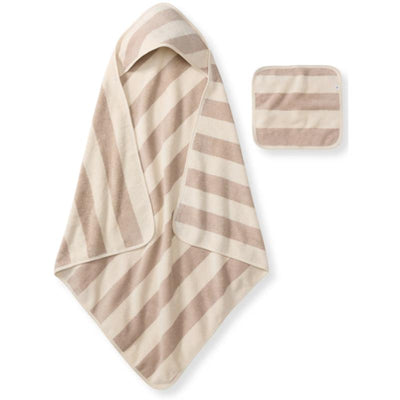 Organic cotton towel and washcloth set in oat color with alternating cream and light brown stripes.