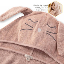 Burts Bees organic cotton toddler hooded bunny towel in soft pink with bunny face and ears, labeled for care.