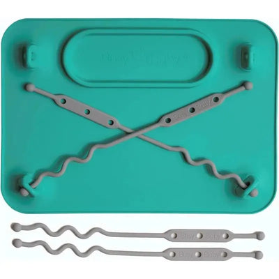 Silicone mat in spearmint color with suction cups and four gray straps designed to secure baby essentials.