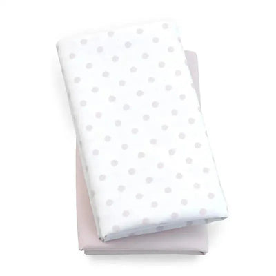 Chicco 2 Pack Lullaby Playard Sheets in pink and white, featuring a pink sheet and a white sheet with gray dots.