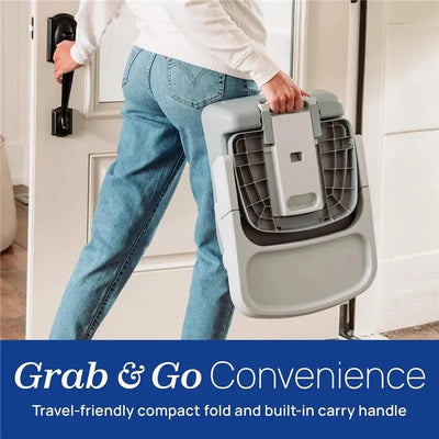A person carrying a Chicco Bento 3-In-1 Booster Seat in Mochi color, showcasing its compact design and built-in handle.