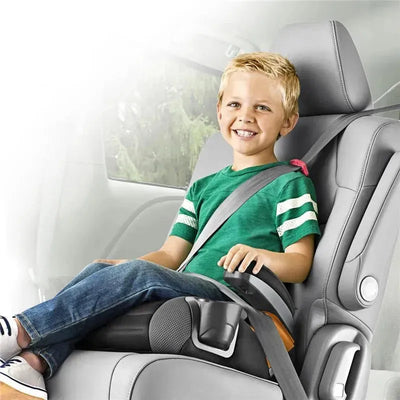 Chicco GoFit Backless Booster Car Seat in Raindrop design, occupied by a smiling boy wearing a green shirt and seatbelt.