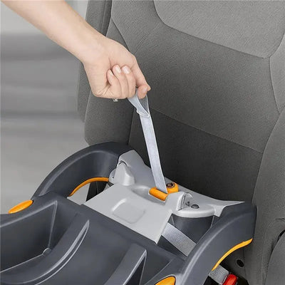 Hand adjusting the strap of a Chicco KeyFit and KeyFit 30 infant car seat base in black and grey, securing it in place.