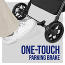 Foot pressing a one-touch parking brake on the Chicco Urbino Lightweight Stroller, with black wheels visible.
