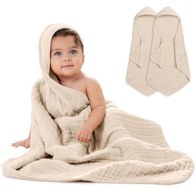 Hooded towels in sand color, featuring a baby wrapped in a soft, layered towel, showcasing comfort and warmth.
