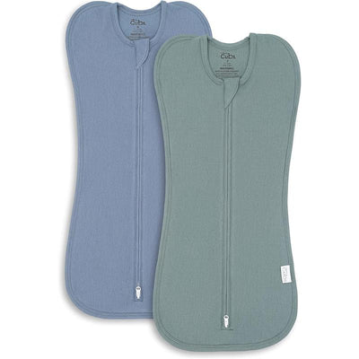 Two swaddle blankets for baby boys in Nomadic Blue and Azul colors, featuring zippers and soft fabric.