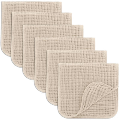 Six beige muslin burp cloths stacked with a soft, textured surface, ideal for baby feeding and cleanup.