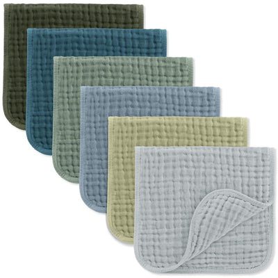 Muslin burp cloths in various colors including green, blue, and gray, featuring a soft, quilted texture.