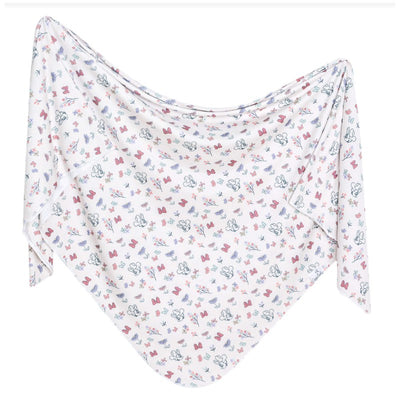 Knit blanket featuring a whimsical Disney Minnie Mouse Bowquet print with flowers and bows in soft pastel colors.