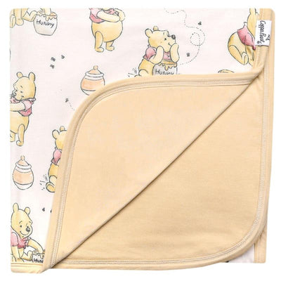 Large Premium Knit Baby Quilt Blanket featuring Winnie the Pooh and honey motifs, soft tan backing.