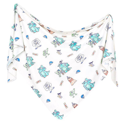 Knit blanket featuring colorful Monsters, Inc. characters on a white background, ideal for children.