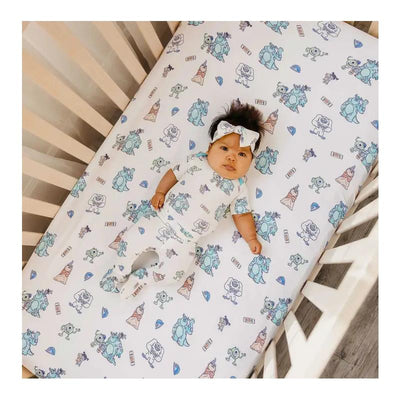 Copper Pearl Monsters Inc Friends Premium Crib Sheet featuring colorful cartoon characters with a baby dressed in a matching outfit.