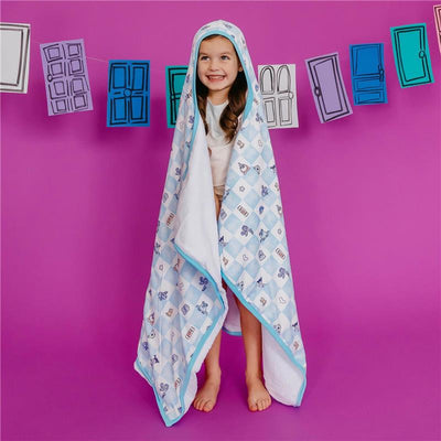 Big kid hooded towel featuring a colorful Monsters Inc. design, worn by a smiling girl against a purple background.