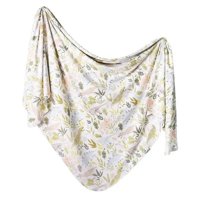 Knit baby swaddle blanket with soft, pastel animal and leaf patterns, designed for comfort and warmth.