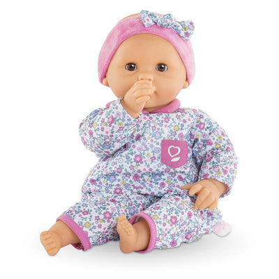 Bébé Calin Capucine baby doll with sleeping eyes, wearing a floral outfit and pink headband, with a vanilla scent.