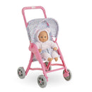 Corolle Dolls Floral Pushchair in pink with a floral-patterned canopy, holding a 30 cm doll in a fluffy outfit.